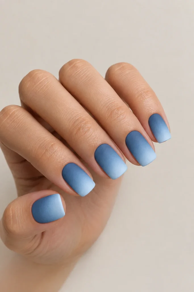 Matte denim blue fading into lighter blue nails