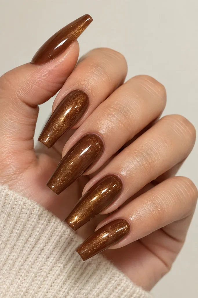 Glazed brown nails with gold chrome powder finish