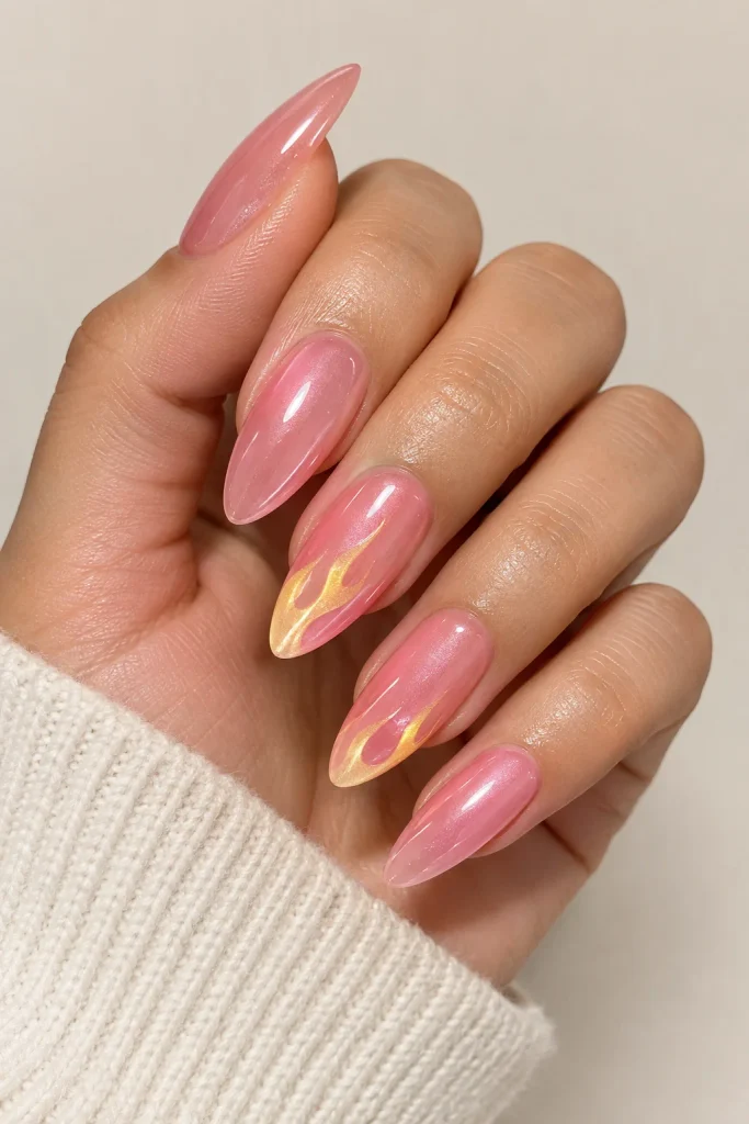 Glazed pink nails with yellow flame nail accents