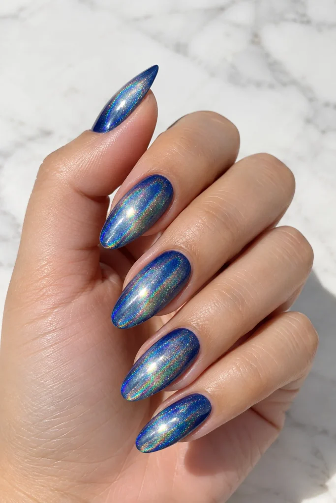 Holographic silver nails over a deep blue base