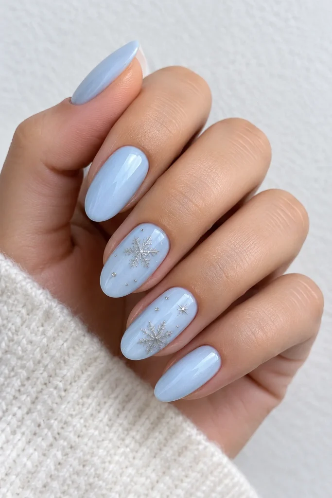 Icy blue nails with silver snowflake details