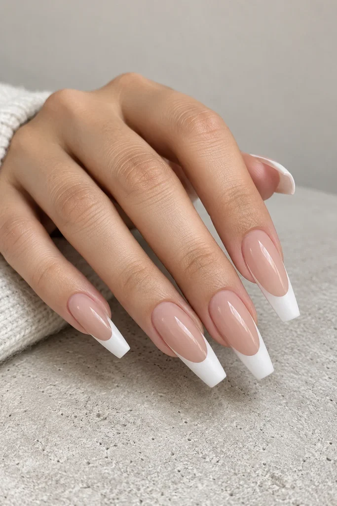 Glossy nude coffin nails with contrasting matte white tips
