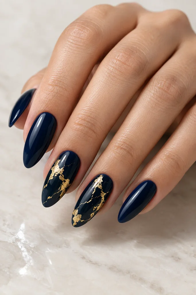 Navy blue nails with gold foil accents