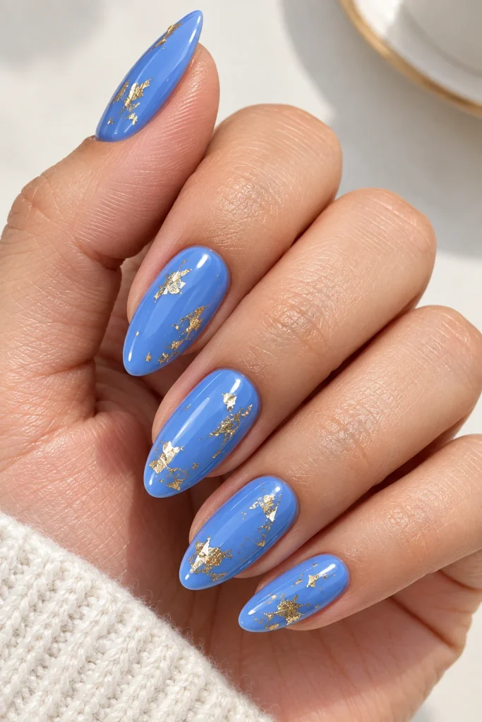 Cornflower blue nails with delicate gold foil flecks