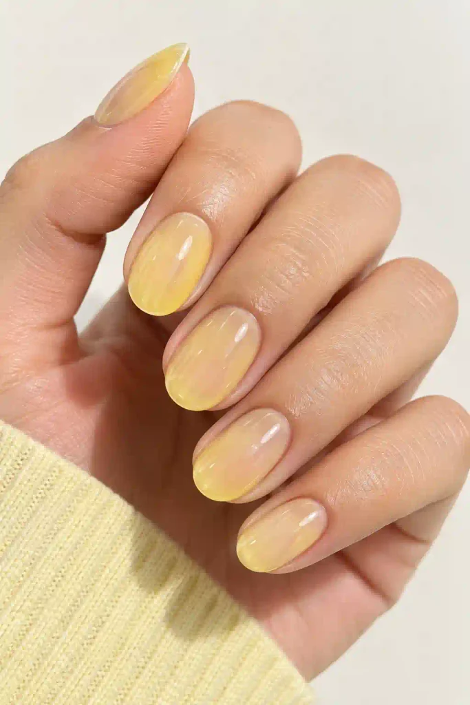 Pastel yellow jelly nails with sheer finish