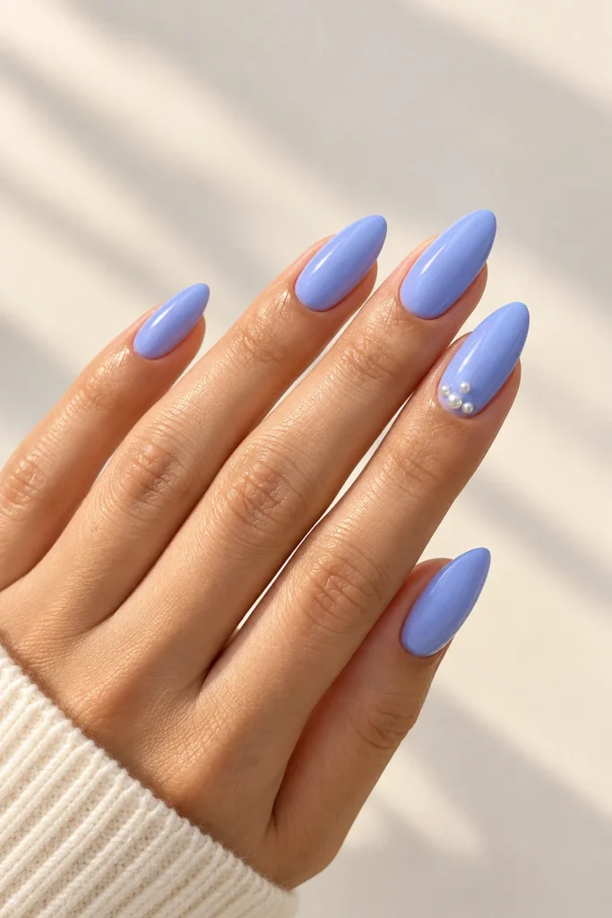 Periwinkle almond nails decorated with tiny pearls