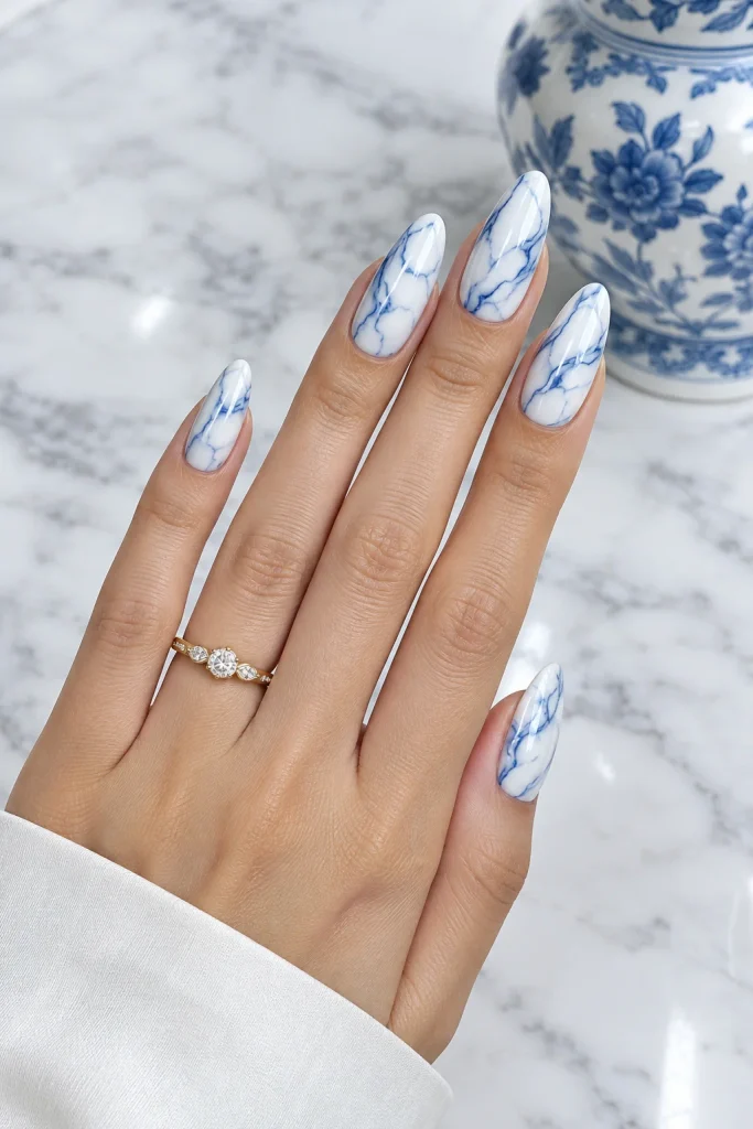 Porcelain blue and white marble almond nails