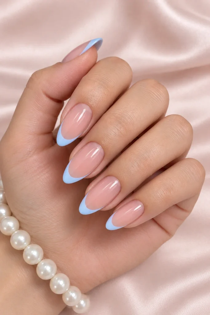 Powder blue French tips on almond-shaped nails