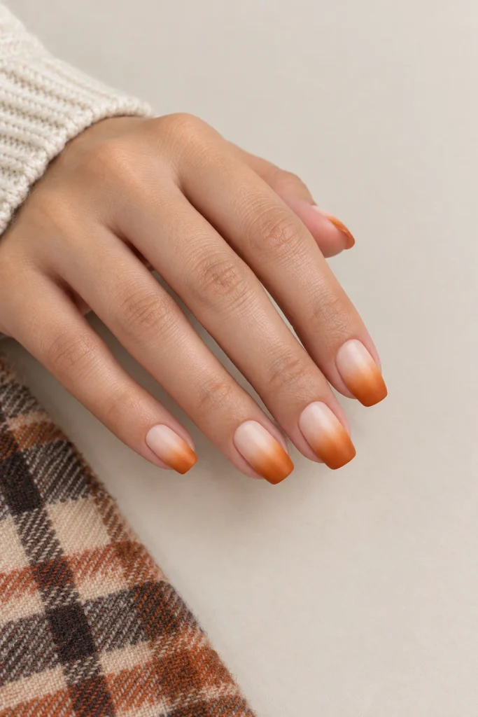 Pumpkin spice ombre nails fading from cream to burnt orange