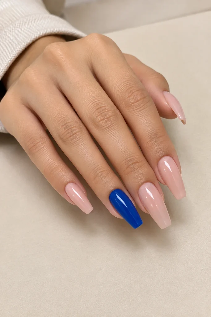 Royal blue accent nails paired with neutral coffin nails