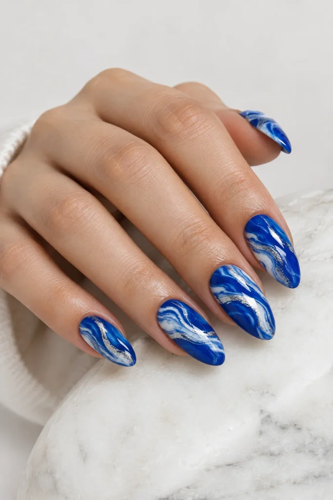 Royal blue marble nails with white swirling details