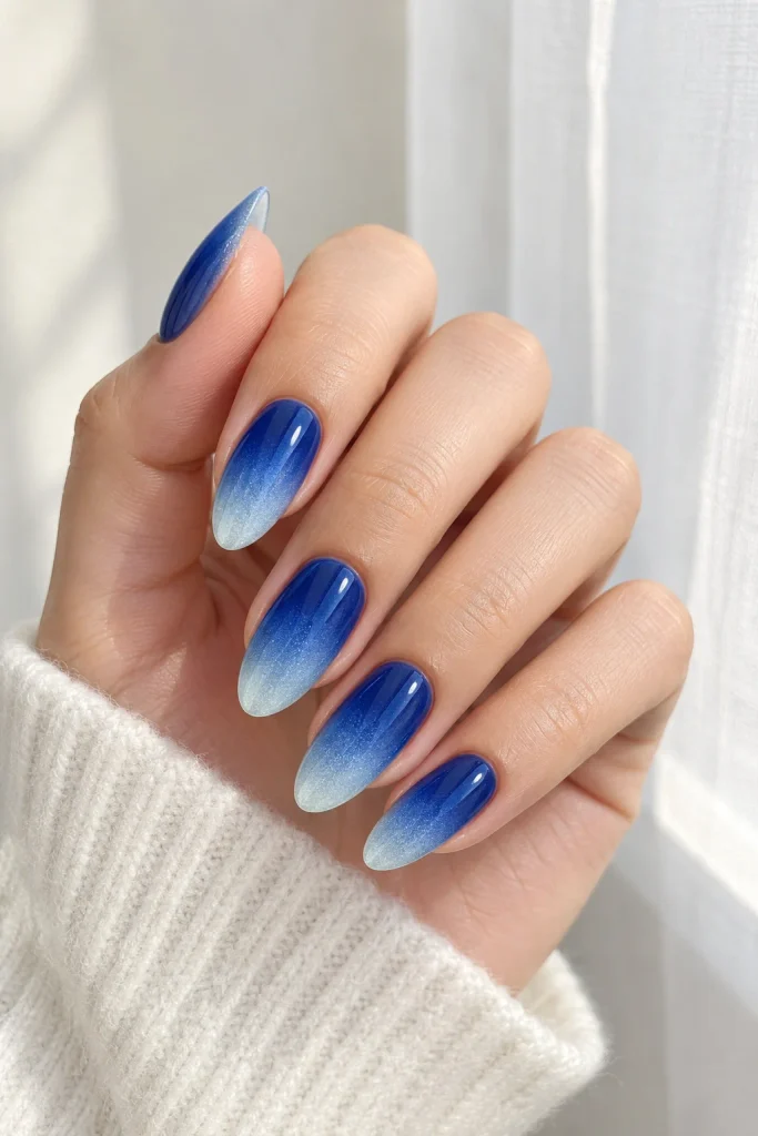 Royal blue ombre nails fading into soft baby blue
