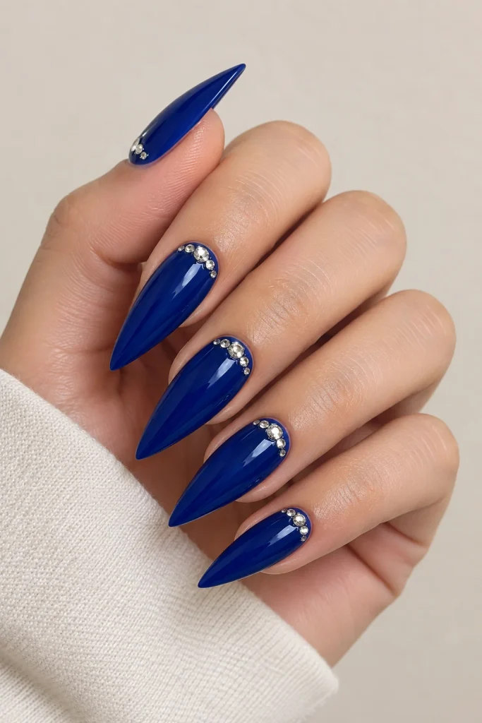 Royal blue nails adorned with delicate rhinestone details