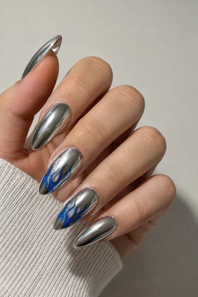 Metallic silver nails with blue flame accents