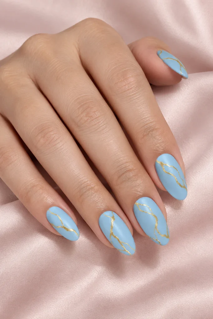 Sky blue nails with gold marble swirl details