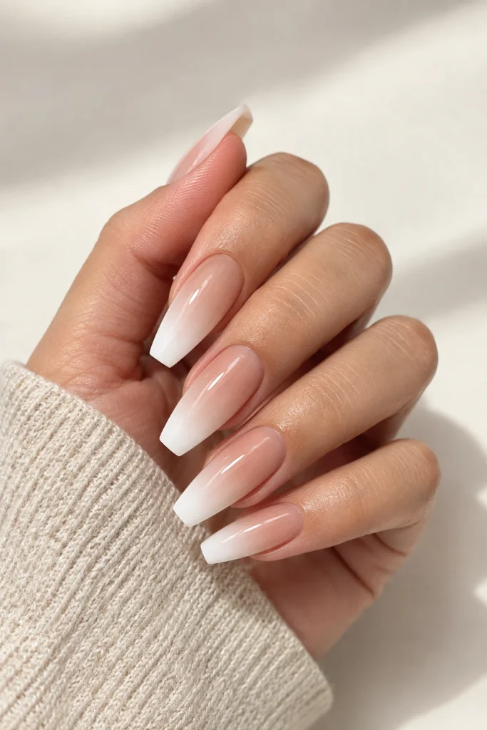 Soft nude to white ombre coffin nails with glossy finish