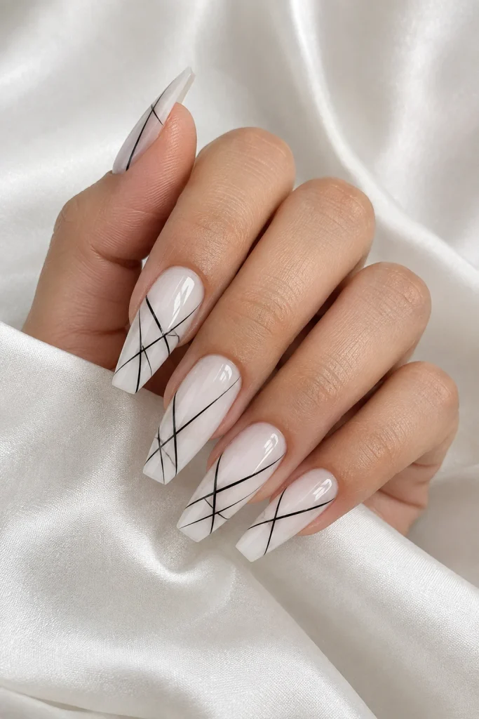 Milky white nails with thin diagonal black lines