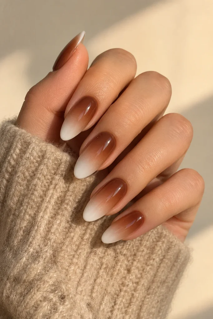 Warm brown ombré fading into soft white nails