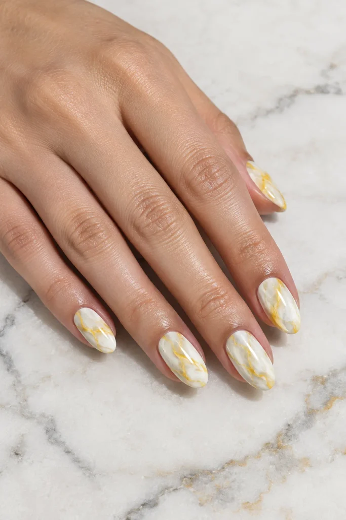 White marble nails featuring delicate yellow veins