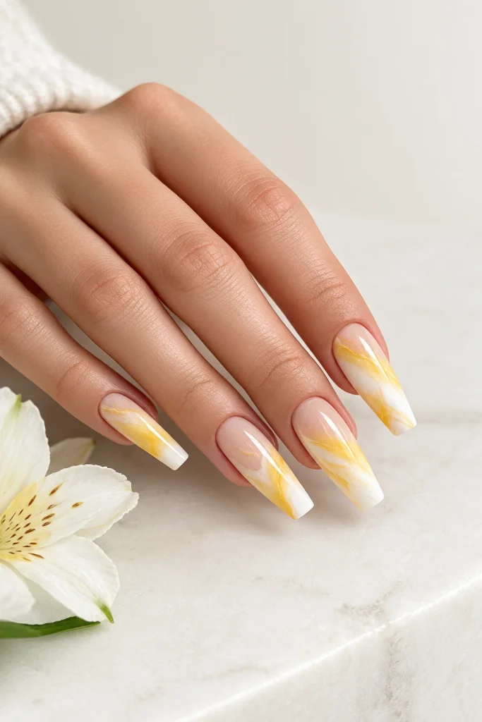 Yellow and white marble coffin nails with artistic swirls