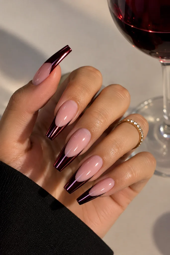 Long coffin nails with mirror-shine black cherry chrome French tips.