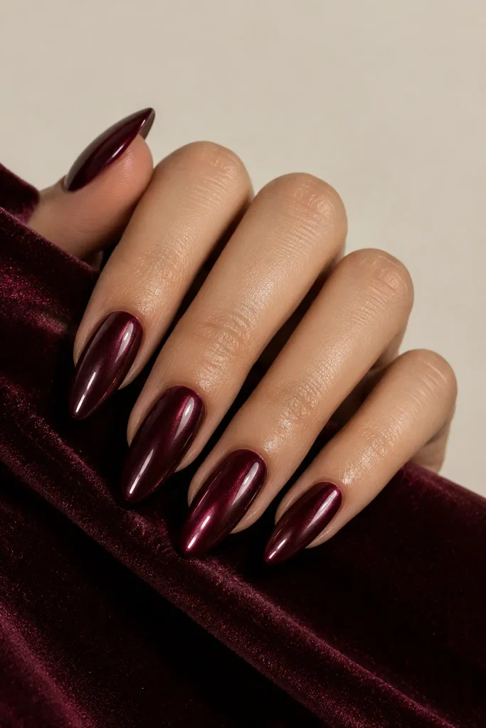 Dark cherry nails featuring a sleek reflective chrome finish