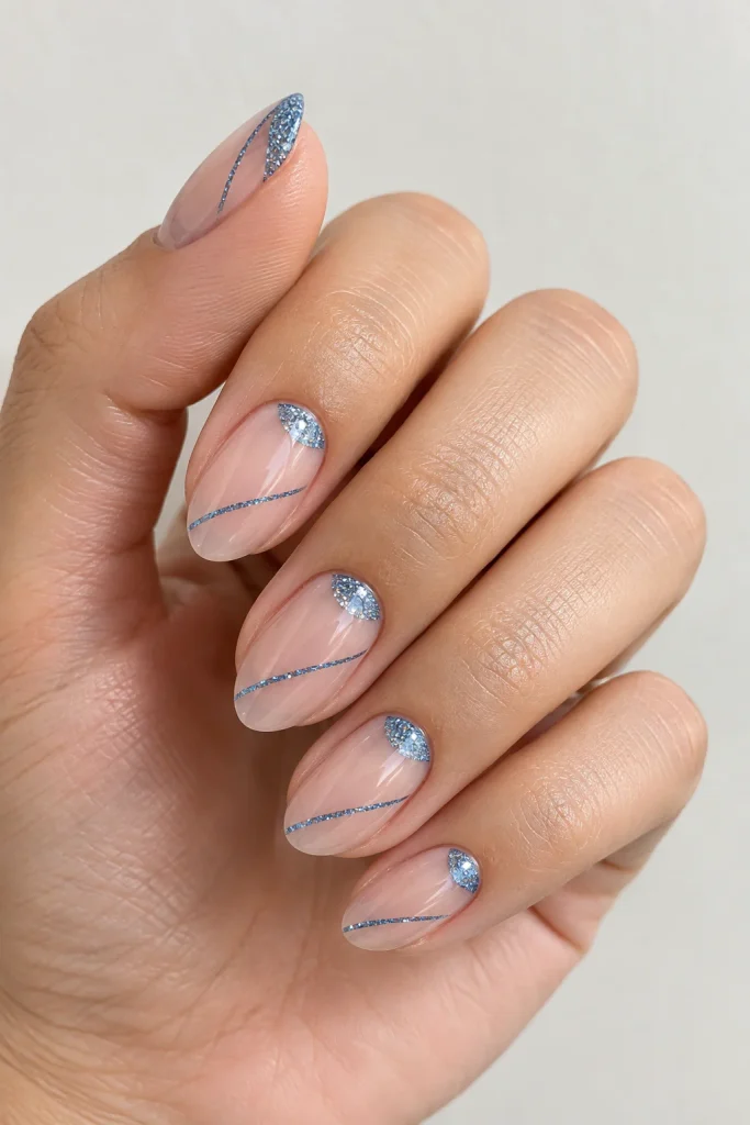 Blue glitter negative space nails with modern designs
