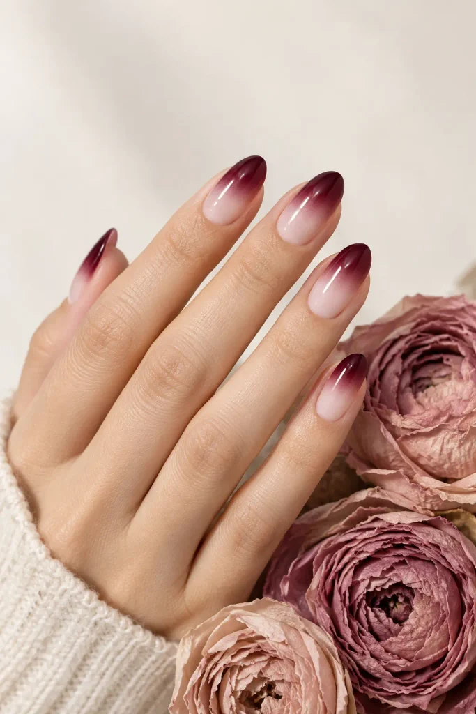 Burgundy to nude ombre nails with seamless color blending