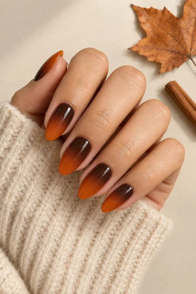 Burnt orange ombre nails fading into glossy chocolate brown