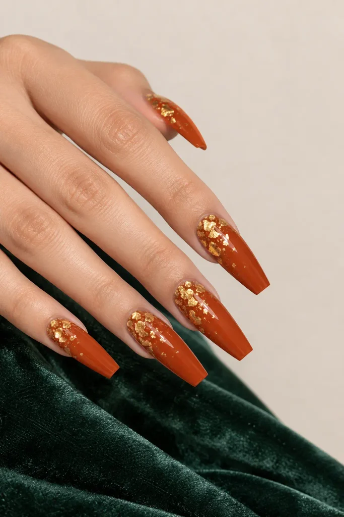 Burnt orange coffin nails decorated with delicate gold foil