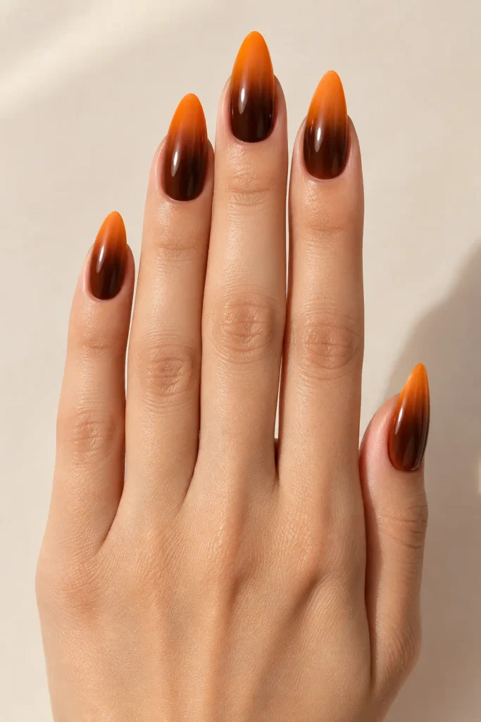 Chocolate brown fades into warm pumpkin orange almond nails
