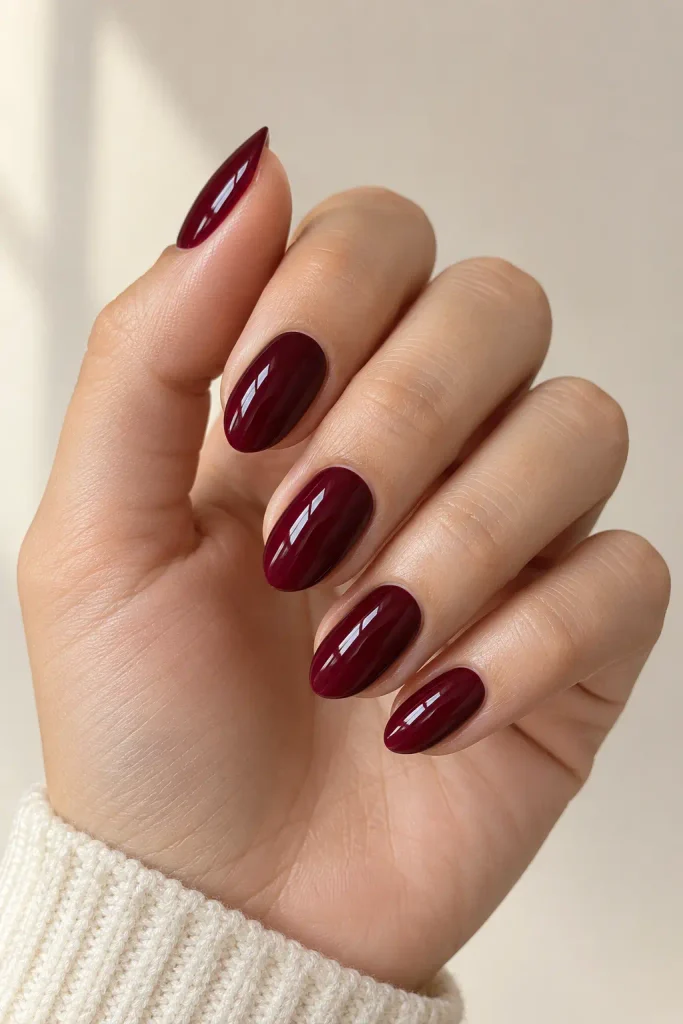 Classic glossy burgundy fall nails on short almond-shaped fingers