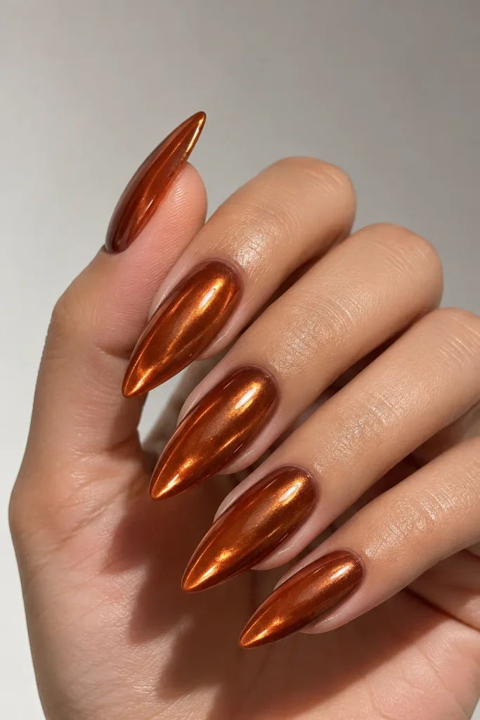 Glazed burnt orange almond nails with reflective copper chrome