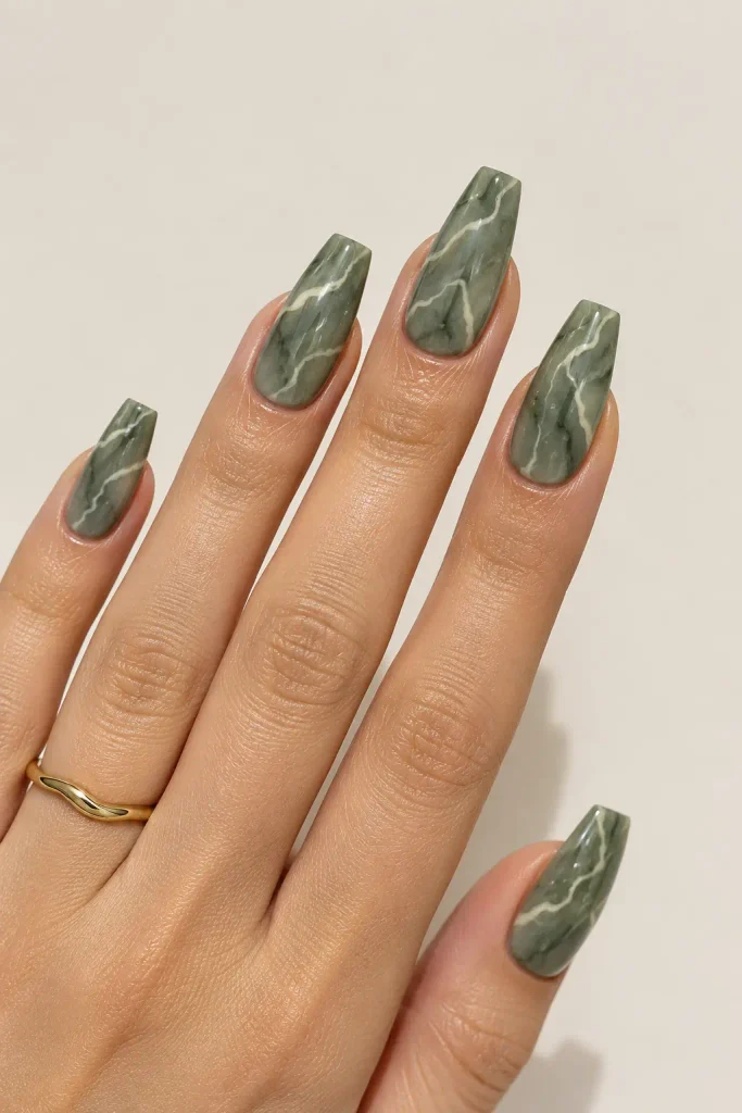 Muted green marble nails with delicate cream veins