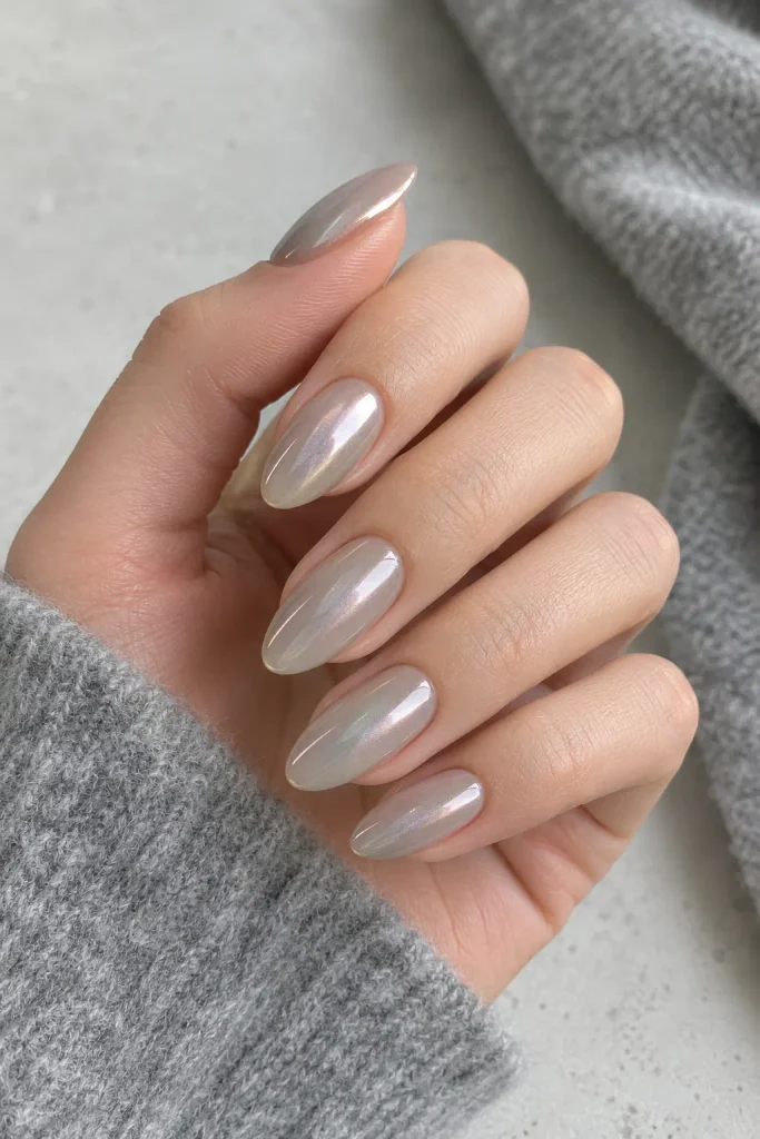 Greige dip nails with a delicate pearl chrome veil