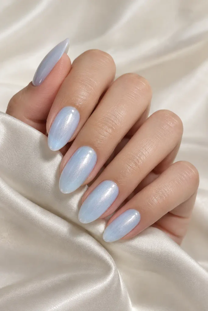 Milky powder blue almond nails with a soft pearl shimmer.