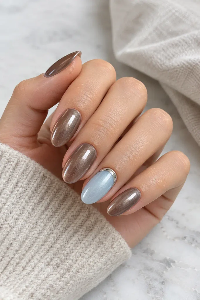 Mocha chrome manicure featuring icy blue accent nails