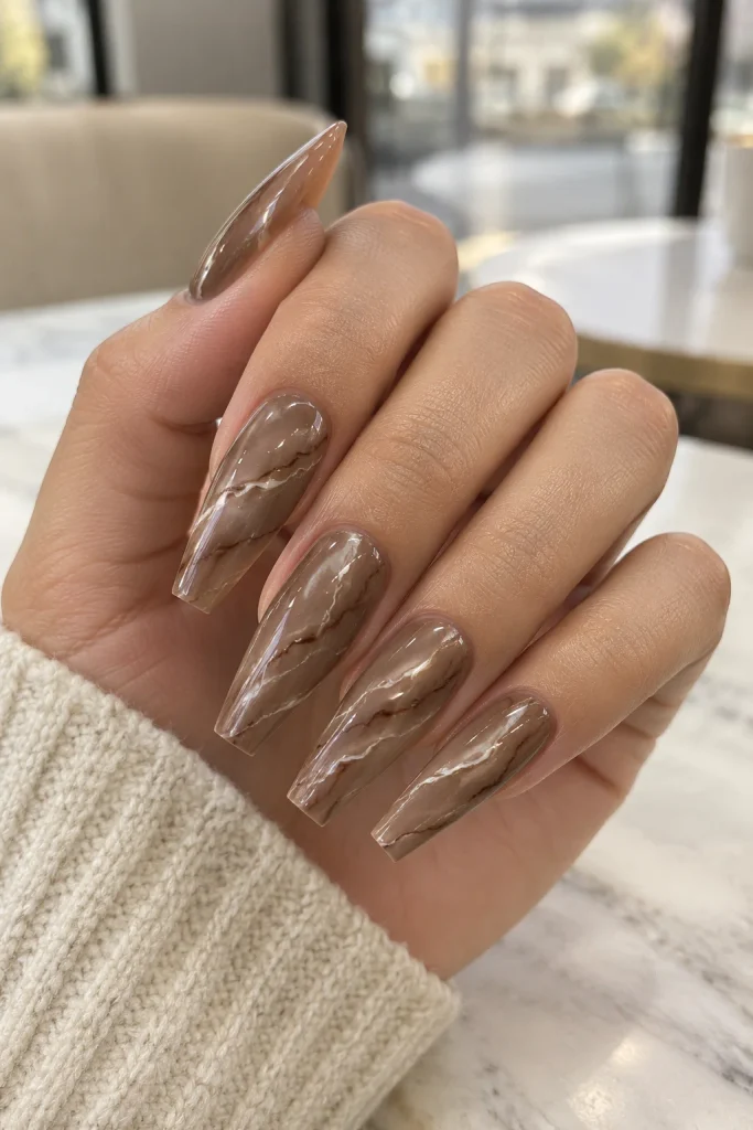 Mocha mousse marble nails with creamy brown swirls