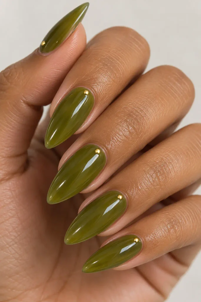 Olive green jelly stiletto nails with translucent glossy layers.