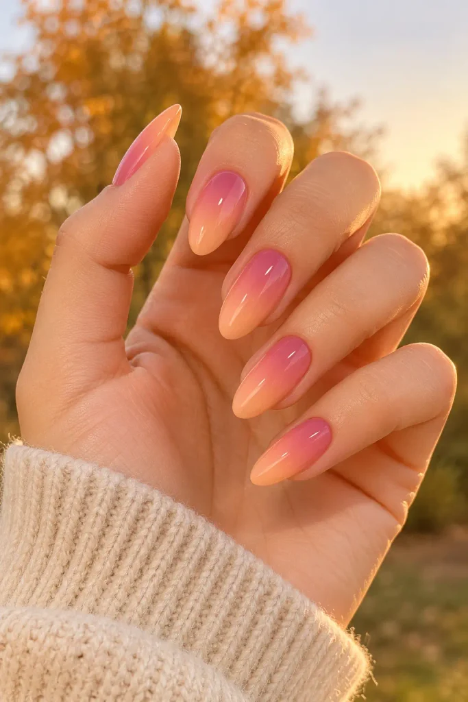 Peach pink ombre nails blending into soft sunset hues