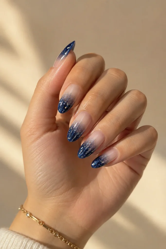 Sapphire blue glitter fade on medium almond nails