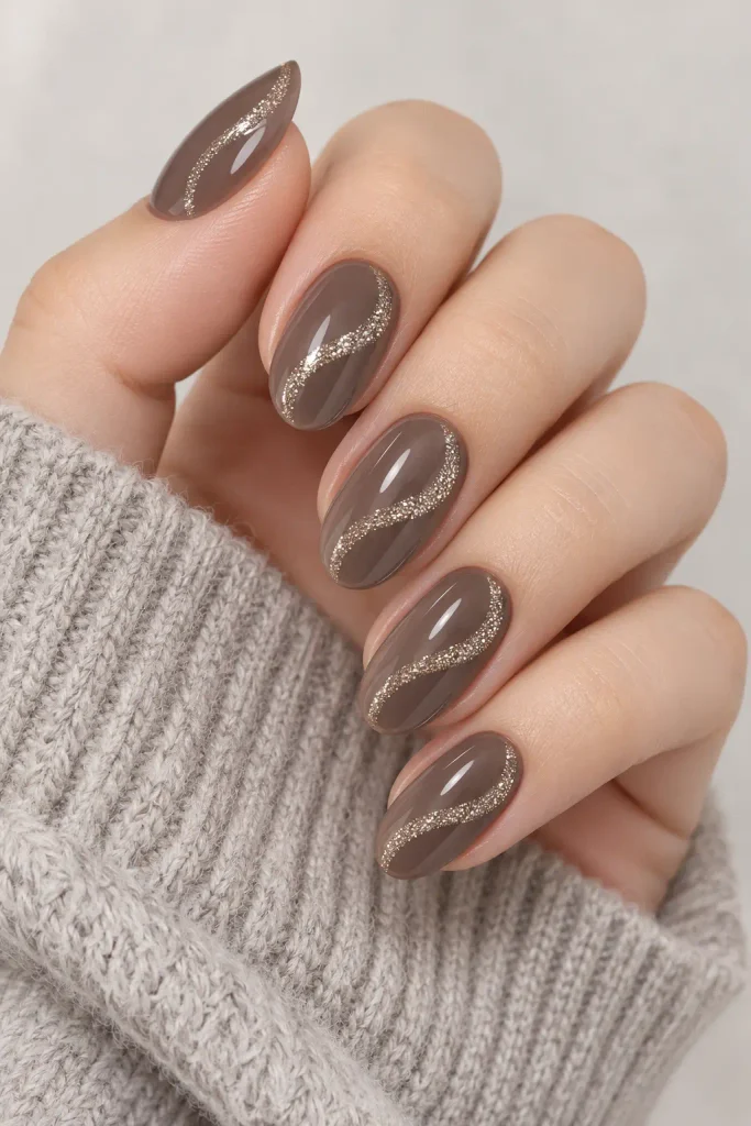 Smoky taupe nails featuring delicate glitter ribbon swirls
