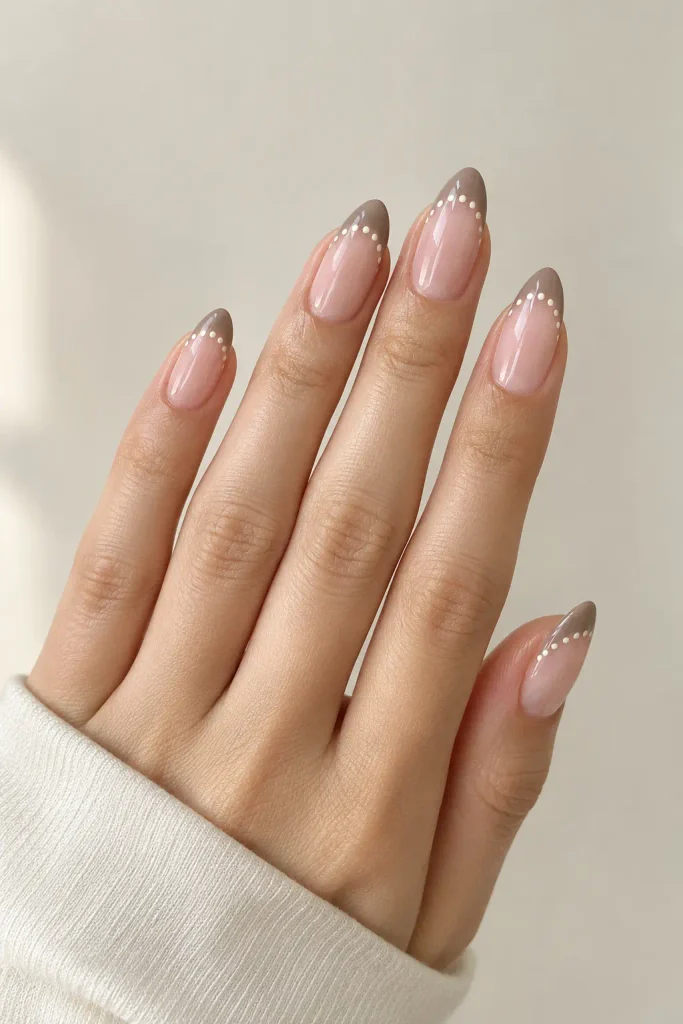 Soft taupe French tips accented with delicate ivory dots