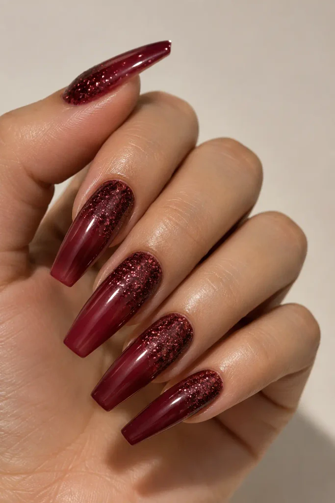 Wine red nails with glitter fading from cuticles